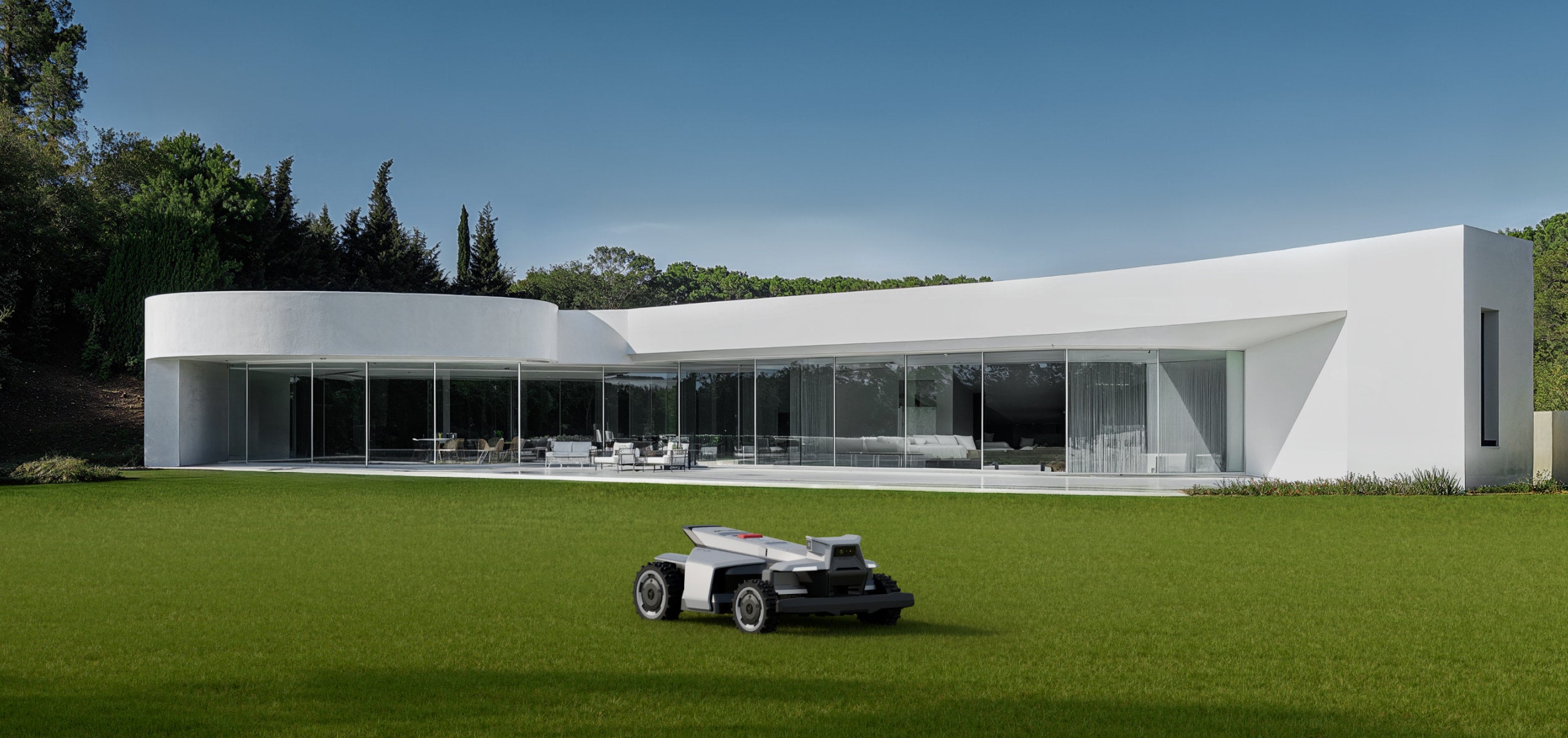 Navimow i110E robot lawn mower in front of modern house.