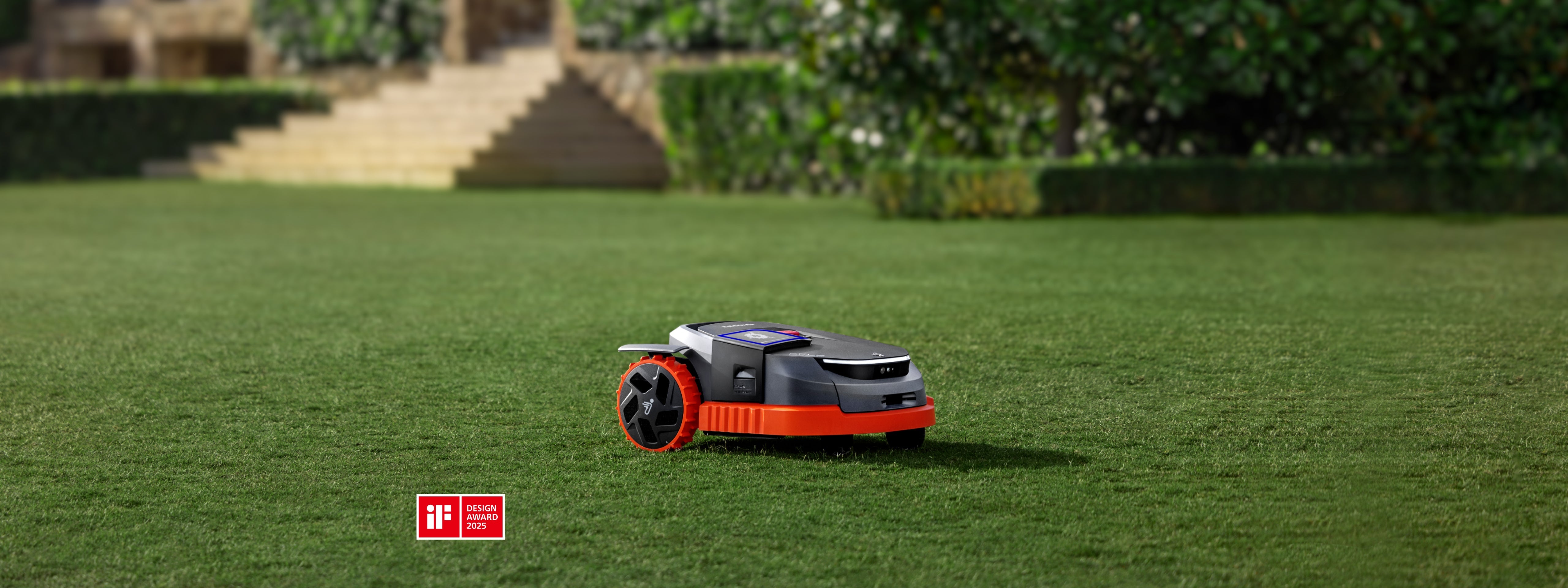 A Navimow i110N robot lawn mower on a green lawn.