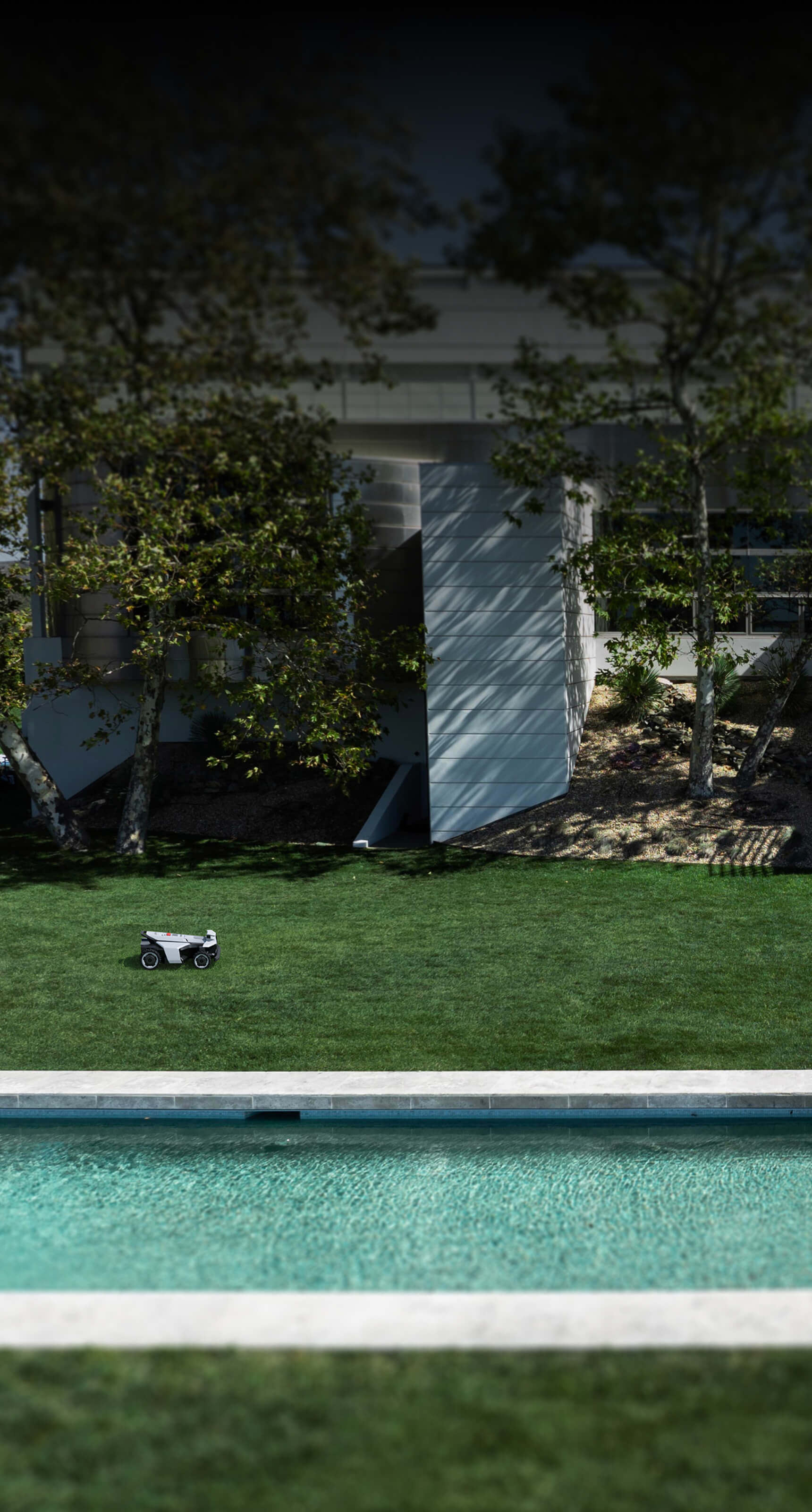 Navimow i105E robot lawn mower on a bright green lawn.