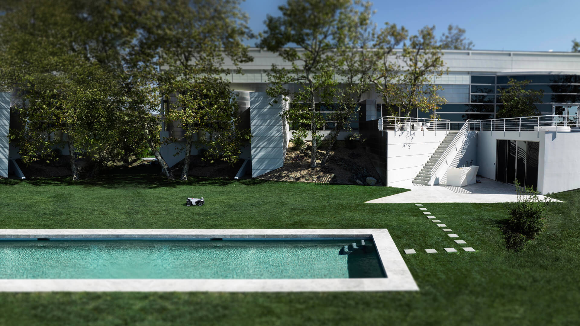 Navimow i110E robot lawn mower on a large green lawn.